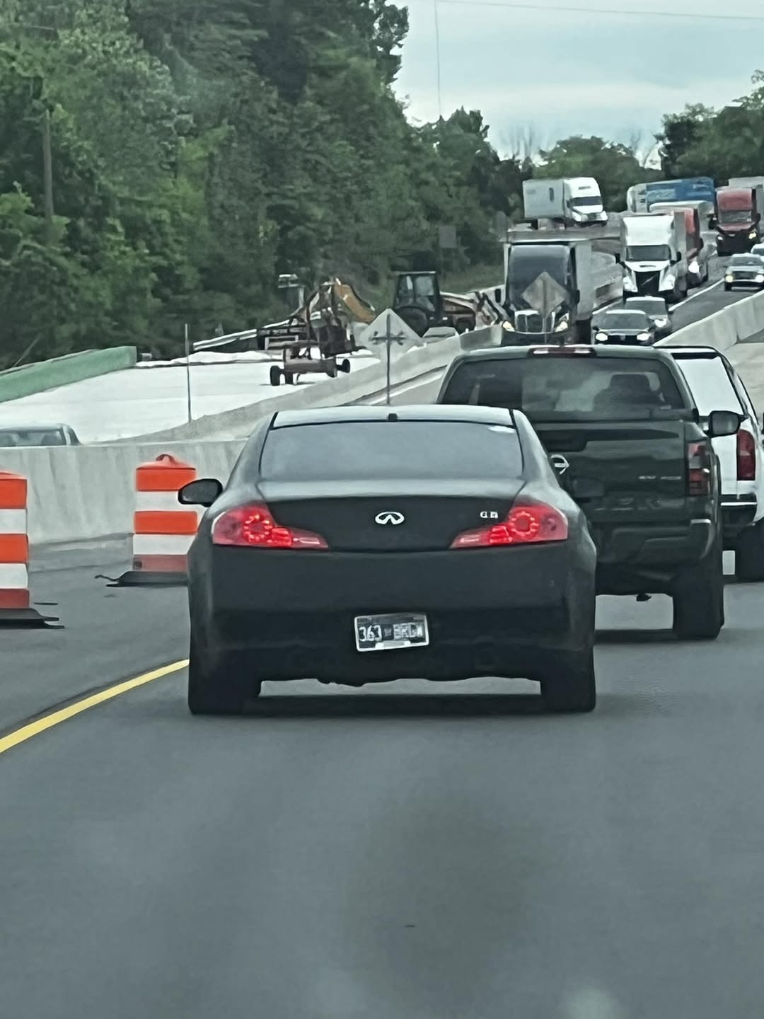 A black coupe in highway traffic
