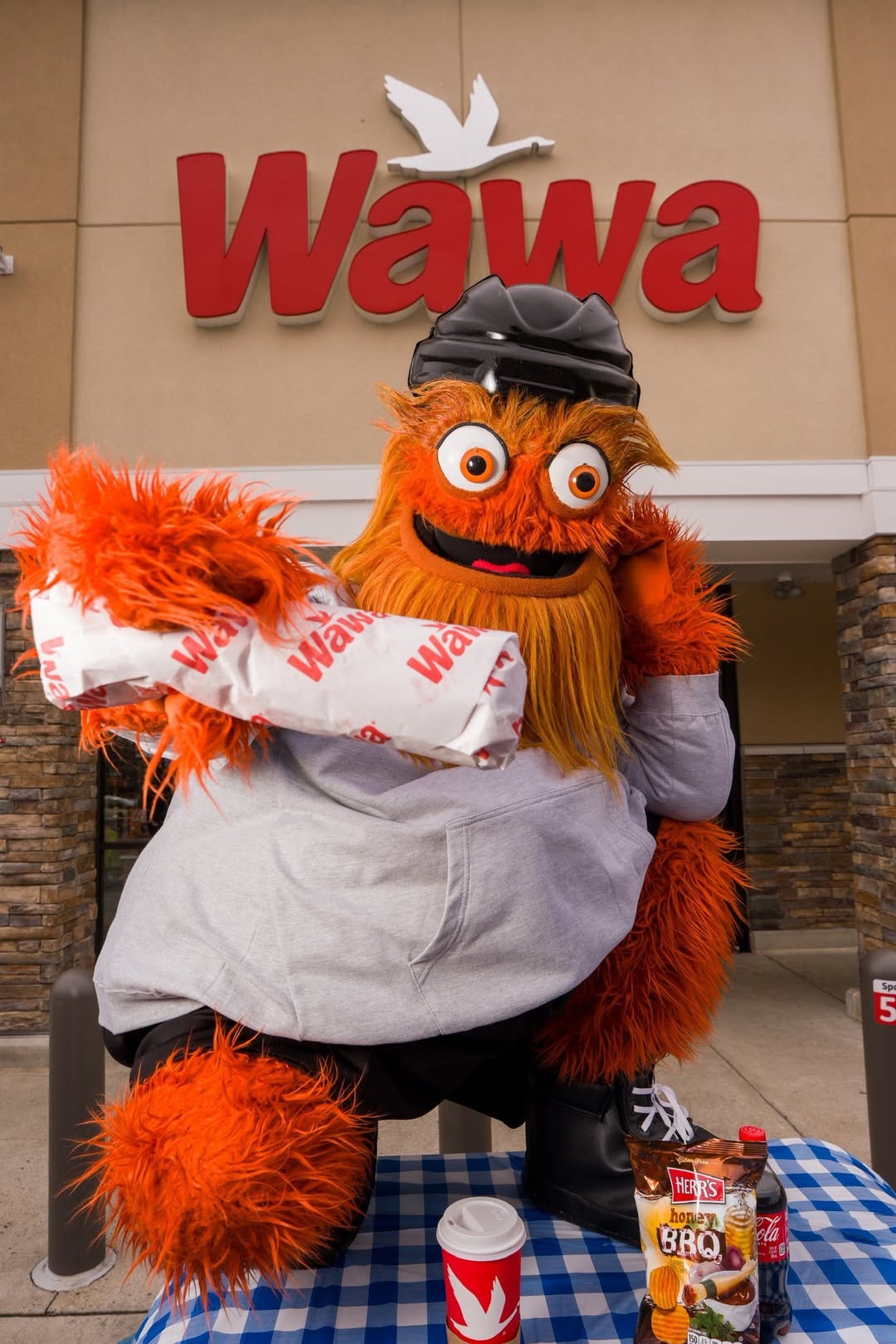 Gritty mascot eating a Wawa hoagie